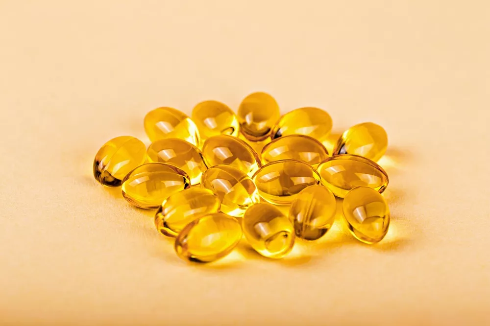 vecteezy_yellow-capsules-on-beige-background_49730184 (1).jpg